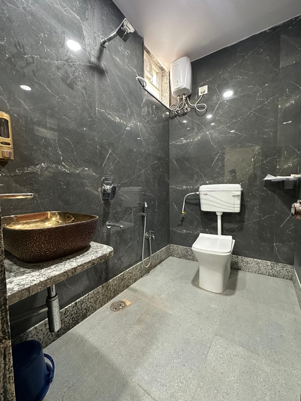 Marble bathroom with hammered brass basin